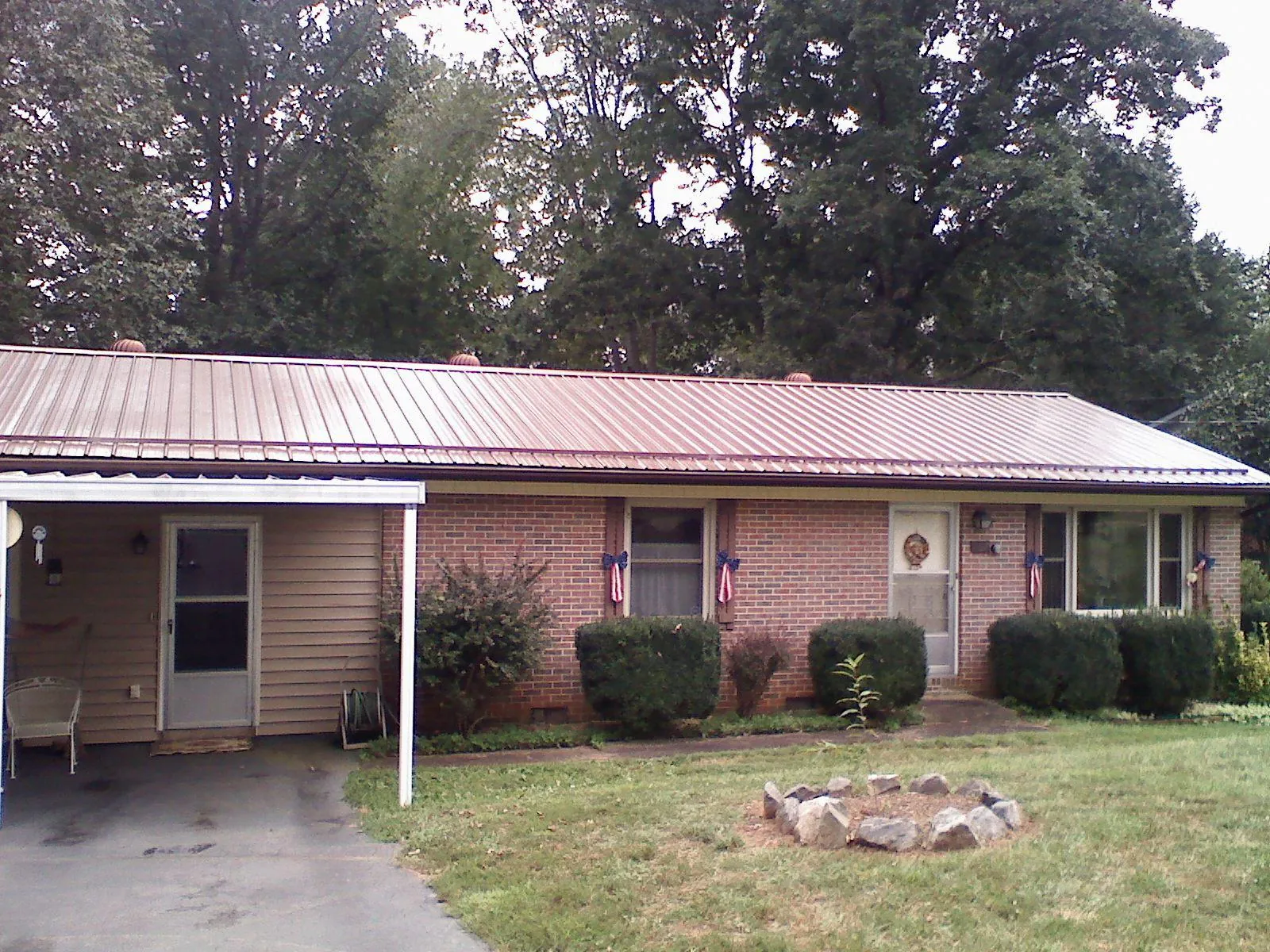 Bronze metal roof and carport on a brick ranch home — Roof Repair work by our crew in Fort Thomas
